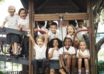 Group of diverse kindergarten students at playground together